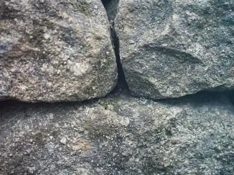 A close view of dry-laid stone, showing the grain and fit between individual stones.